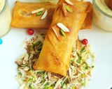 A picture of step 11 of Moong Dal Halwa Cigars dipped in Shaahi Rabdi.