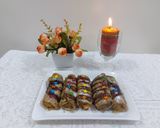 A picture of step 4 of Banana cinnamon bread rolls with chocolate syrup garnish.