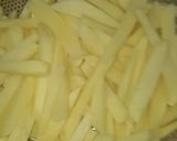 A picture of step 2 of Kibda (Egyptian liver sauce) and French fries.