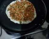 A picture of step 4 of Rava Uttapam with veggies, packed with fruits and dryfruits.