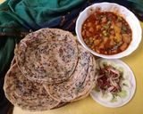 A picture of step 8 of Masala laccha paratha with aloo matar in tomato gravy.