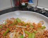 A picture of step 3 of Pork Al pastor with sauteed onions and peppers.