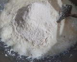 A picture of step 2 of Coconut fritters deep in sugar syrup.