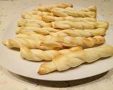 A picture of step 3 of Puffy pastry twists wrapped in parma ham.