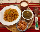 A picture of step 5 of Punjabi thali (chole with rice, creamy Palak paneer, spicy onion lachcha and refreshing lassi).