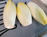 A picture of step 1 of Endive Salad with Tomatoes, Black Garlic, and Feta.