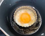 A picture of step 5 of Corn cake with bacon and sriracha mayo sunny side up.