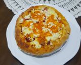 A picture of step 5 of Pizza covered with homemade Mozzarella Cheese & Sausage.