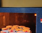A picture of step 5 of Christmas special vanilla tutti fruti cup cakes.