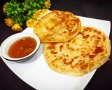 A picture of step 6 of Khatti meethi karee ki chutney with paratha.