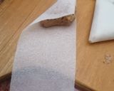 A picture of step 3 of Samsa with pastry sheets stuffed with almonds.