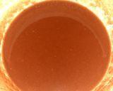 A picture of step 3 of Indian snack (crisp sphere with flavoured water/curd mixture).