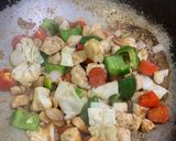 A picture of step 4 of Almonds and cashew nut chicken.