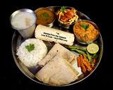 A picture of step 4 of Kathiyawadi Lunch Thali (Dahi Tikhari, Sev Tameta Nu Shak, Dal Bhaat, Fulka Rotli, Chaas, Papad).