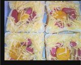 A picture of step 2 of Cheesy egg in a hole baked toast.