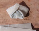 A picture of step 4 of Tofu Garlic Chive Dumplings in Chili Broth.