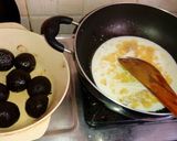 A picture of step 2 of Oreo biscuit balls dipped in chocolate sauce.