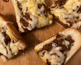 A picture of step 3 of Sloppy joes stuffed french bread.
