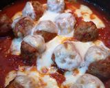 A picture of step 7 of Mozzarella pork meatballs over spaghetti.