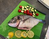 A picture of step 1 of Roasted whole sea bream with all the trimmings on one roasting tin.