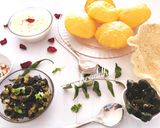 A picture of step 10 of Turiya patra with poori and basundi.
