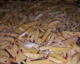 A picture of step 1 of Masala French fries with any fried item.