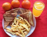 A picture of step 4 of Cheese and Tomato Grilled Sandwich with French Fries.