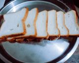 A picture of step 1 of Halloween spooky bread sandwich with tomato sauce.