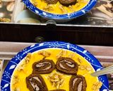 A picture of step 4 of Swiss roll mangoes custard loaded with walnuts.