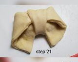 A picture of step 22 of Bow tie buns.