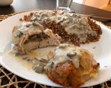 A picture of step 7 of Chicken breast stuffed with mushrooms poured mushroom sauce.