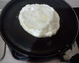 A picture of step 4 of Rava Uttapam with veggies, packed with fruits and dryfruits.