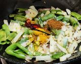 A picture of step 3 of Runner beans and potato fry with onion and onion greens.