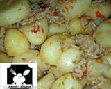 A picture of step 7 of Jollof rice with irish potato.