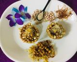 A picture of step 13 of Caramalized peanuts in peanuts-sesame Katoris garnished with spun sugar.