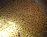 A picture of step 9 of Moong dal khichdi with onion tomato and capsicum tadka.