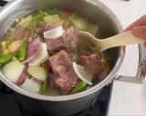 A picture of step 4 of Oxtail Soup Thai style with Herbs.