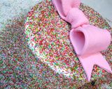 A picture of step 5 of Bow on top full cover sprinkles cake 🎀.