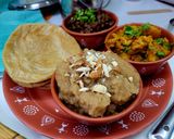 A picture of step 4 of Ashtami Bhog Thali (Halwa, Puri, Kala Chana).