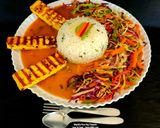 A picture of step 5 of Spicy Grilled Paneer Steak Italian Herb Rice Schezwan Sauce With Exotic Sautéed Veggies Gourmet Meal.