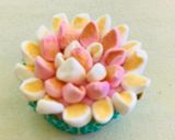 A picture of step 12 of Eggless cupcakesDecorated with buttercream, fondant and marshmallows.