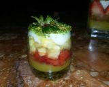 A picture of step 9 of Kunafa and Qashtalia Decorated with Oranges, Strawberries, and Bananas.
