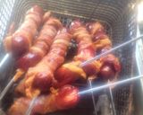 A picture of step 3 of Deep-Fried, Bacon-Wrapped Hot Dogs on Skewers.