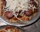 A picture of step 5 of A Real Meat-lovers Pizza and Cheesy Pizza.