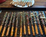 A picture of step 5 of Christmas chocolate covered pretzel rods.