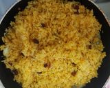 A picture of step 2 of Turmeric rice with raisins.
