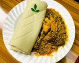A picture of step 10 of Egusi soup and rolled up pounded yam.