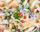 A picture of step 2 of Loaded Poppadoms / Poppadum Nachos topped with chilli and herbs 🌿🌱.