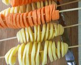 A picture of step 4 of Spiral potato and carrots on stick.