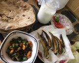 A picture of step 10 of Bhindhi with tali hui sabz mirchain and thandi lassi.